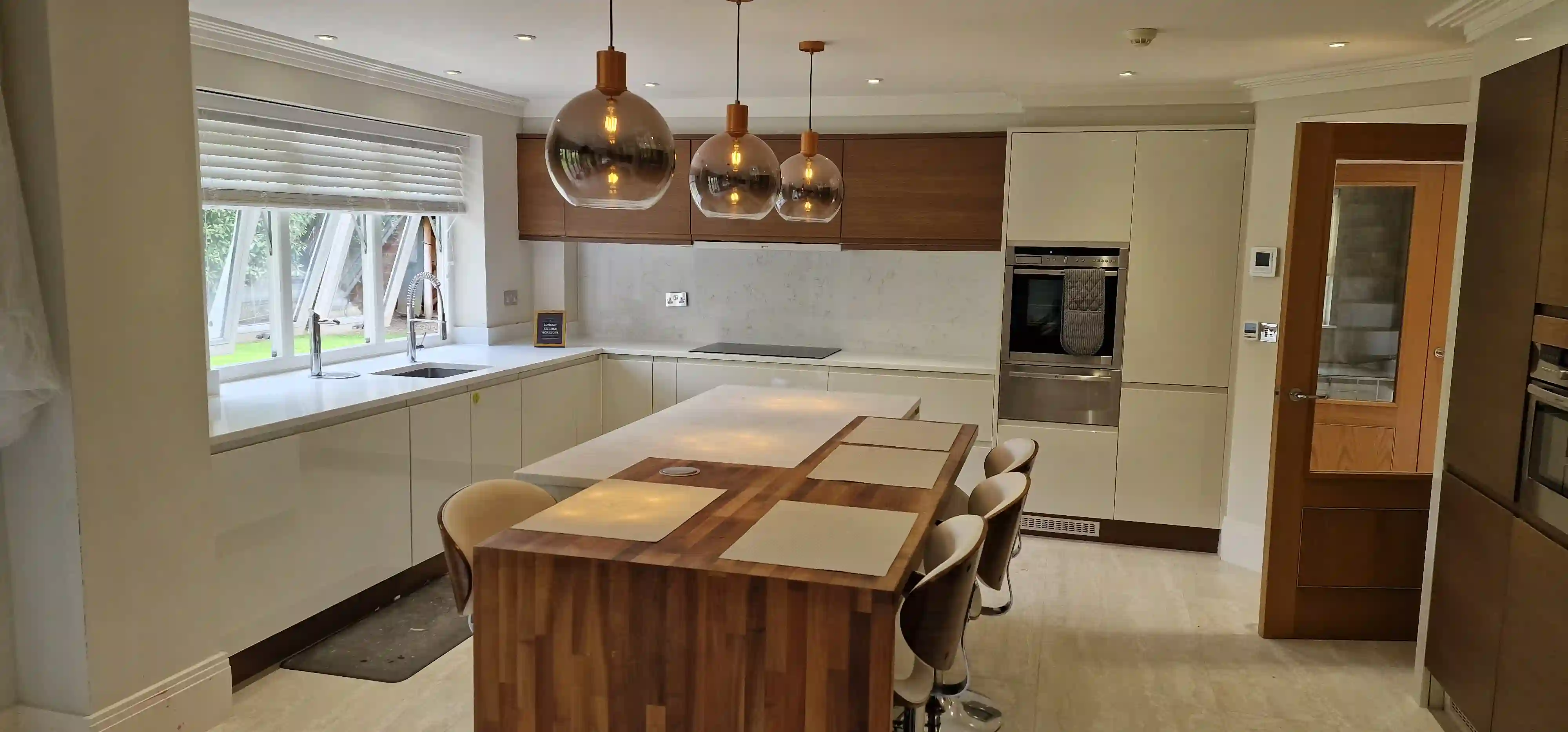 Quartz Splashback Teddington Matching quartz splashback and upstand behind a hob in a Teddington kitchen
